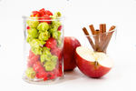Load image into Gallery viewer, Cinnamon Popcorn and Apple Popcorn in clear cup displayed with apple slices and cinnamon sticks
