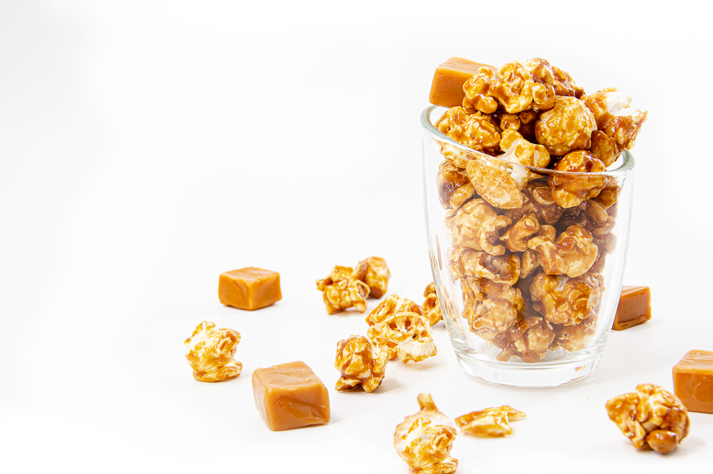 Tasty Caramel Corn in clear cup with soft, chewy caramel candy pieces