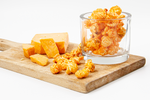 Load image into Gallery viewer, Cheese Popcorn displayed on wood cutting board with real cheese bites

