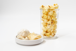 Load image into Gallery viewer, Garlic Parmesan Popcorn displayed with garlic clove in clear cup
