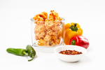 Load image into Gallery viewer, Hot &amp; Spicy Gourmet Popcorn displayed in cup with red pepper, yellow pepper, jalapeno and spices
