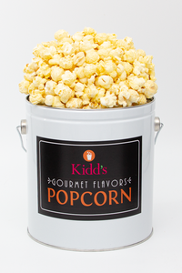 White cheddar flavored popcorn in small white and black popcorn can.